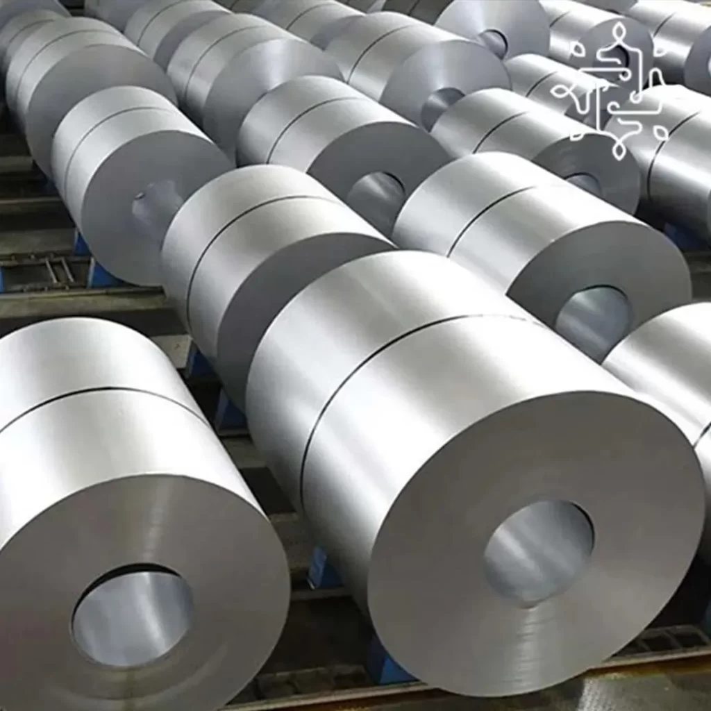 Large aluminum rolls arranged in a factory setting, illustrating the production and handling of metal materials.